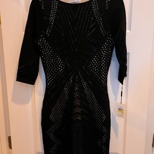 Stunning form fitting black dress with tan underlay details from Calvin Klein
